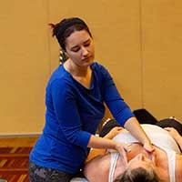 massage therapist performing massage on client